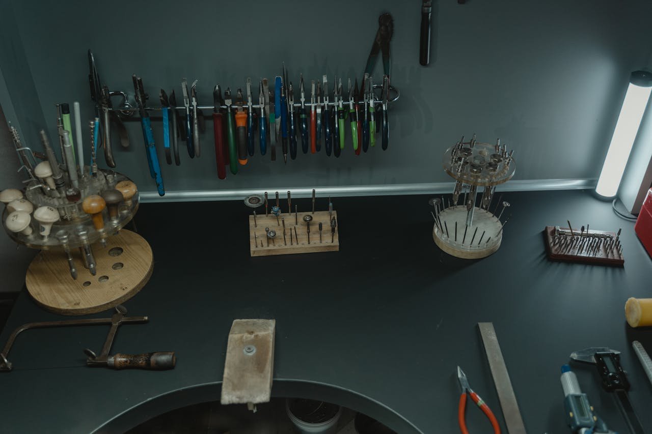 A well-organized jewelers workstation with various tools, pliers, and accessories displayed neatly.